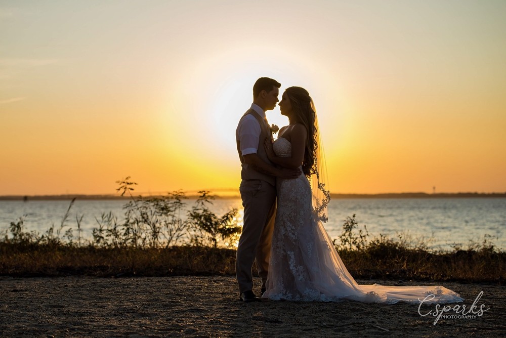 Bride and groom silhouettes infront of sunset