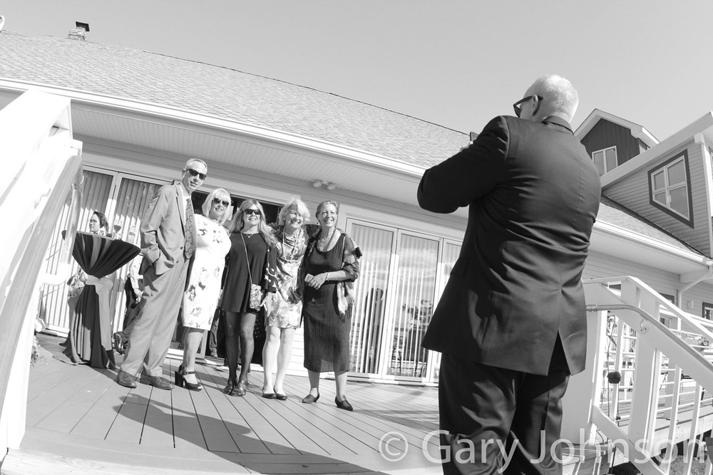 Black and white photo of man taking photo of family